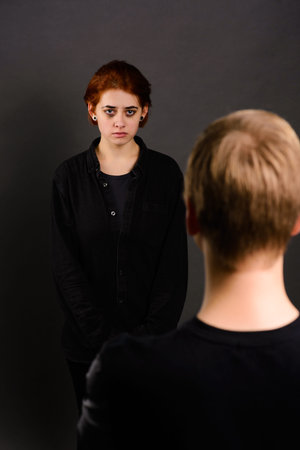 Desparate female with aggressive man in studio, domestic violence conception