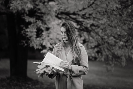 Beautiful woman spending time in a park during autumn season