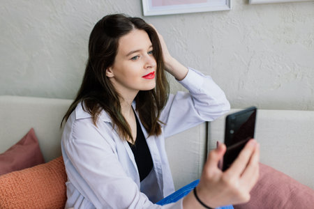 A young woman works in the home office manager or freelancer at work. Distance education. Student woman studying in her room. Online shopping, home work, freelance and online learning conceptの写真素材