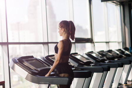 Young woman exercise fitness and workout while run on track in a sport club