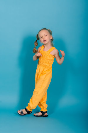 Portrait of beautiful and confident girl isolated on blueの写真素材