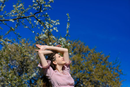 Happiness bliss freedom concept. Woman happy smiling joyful with arms up dancing in summer during...