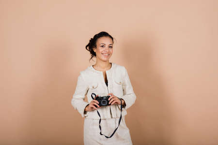 Attractive african american black female, using a slr digital camera taking photographs in studio. Photography student and tourism lifestyle.の写真素材