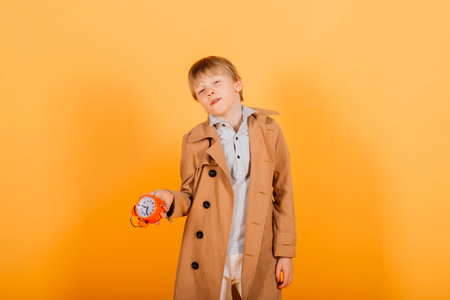 Teen boy holding alarm clock .の写真素材