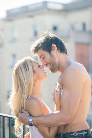 Barcelona, Spain - 06.29.2020. Happy young couple relaxing on balcony at home, tenderのeditorial素材
