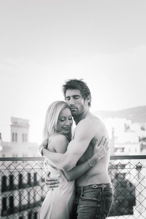 Barcelona, Spain - 06.29.2020. Happy young couple relaxing on balcony at home, tenderのeditorial素材