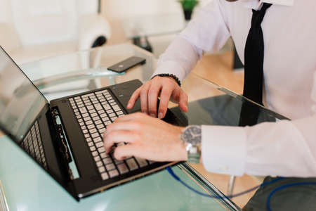 Businessman dressed in shirt having video call on computer in the home officeの写真素材