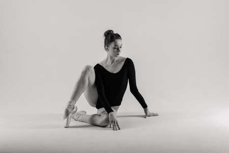 Modern style ballet dancer posing on a studio backgroundの写真素材