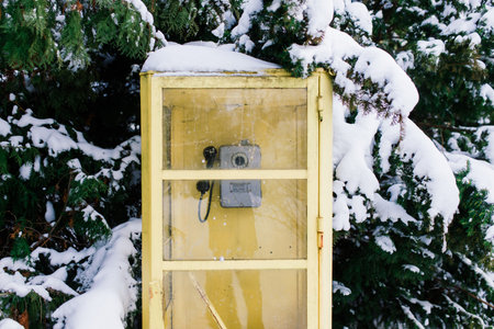 Vintage callbox in winter city park, snow landscapeの写真素材