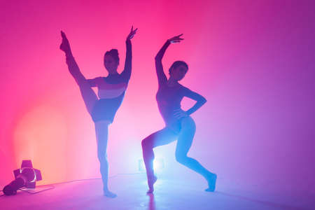 Two modern ballet dancers in black and red bodysuit, studioの写真素材