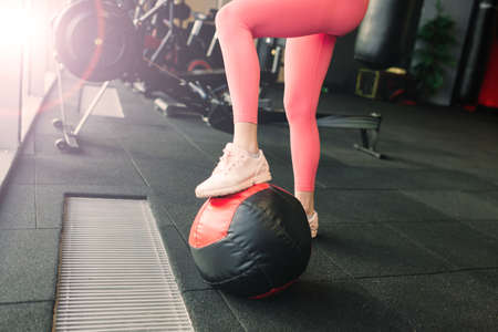 Beautiful woman training pilates with ball in gym, fitnessの写真素材