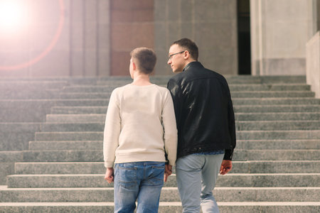 Young gay couple smiling happy and hugging at city.の写真素材