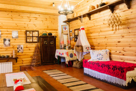 Minsk, Belarus - 02.24.2021. Ancient interior of a rural house in ethnographic park. Old stoveのeditorial素材