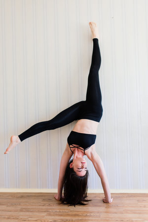 Staying fit and healthy. Beautiful young woman in sports clothing doing yoga while relaxing, home