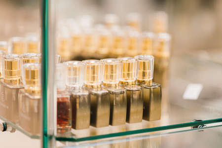 Minsk, Belarus - 03.07.2021. Bottles of perfumes with a taps and multicolored little pails for sale on shelves of cosmetic shopのeditorial素材