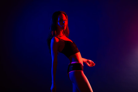 Young and beautiful dancer posing in a studio