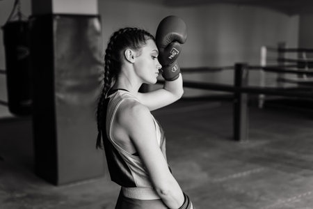 Minsk, Belarus - 05.23.2021. Attractive female training, punching a bag with boxing gloves onのeditorial素材