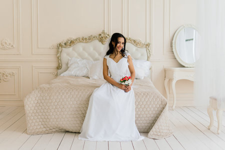 African American bride in dress in morning preparing for the wedding in a hotel roomの写真素材