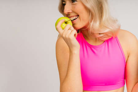 beautiful young sporty muscular woman, isolated against white backgroundの写真素材