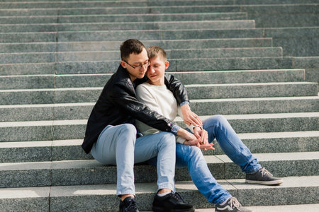 Gay couple walking in a city centre, lifestyleの写真素材