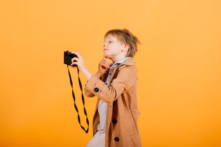Grimacing emotional redhead fasion boy posing in a yellow studioの写真素材