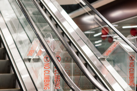 Empty shop escalator in shopping center, no people, isolation covidの写真素材