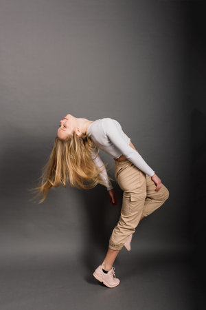 Modern style dancer posing on a studio backgroundの写真素材