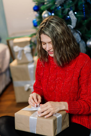 Drink, christmas and hygge concept - close up of happy woman with cup of coffee in a bed at homeの写真素材