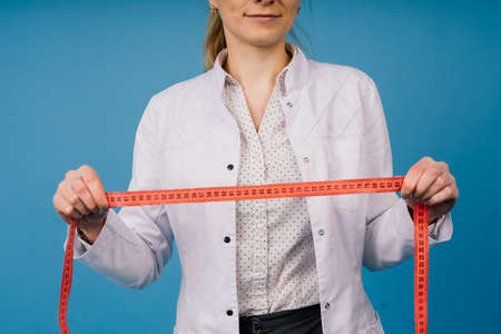 Young doctor woman in a white lab coat, studio shotの写真素材