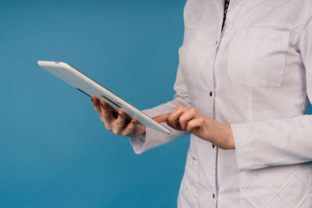Young doctor woman in a white lab coat, studio shotの写真素材