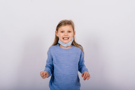 Little cute kid in studio, wearing mask for protection, Coronavirus outbreak concept.