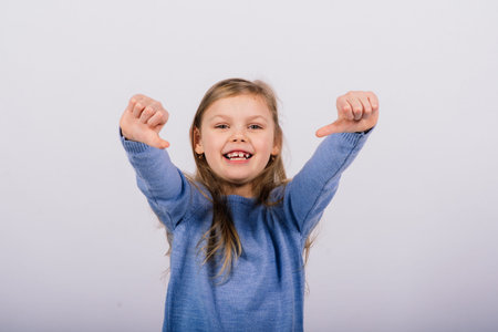 Portrait of beautiful little girl happy smiling on a studio. Isolated white background