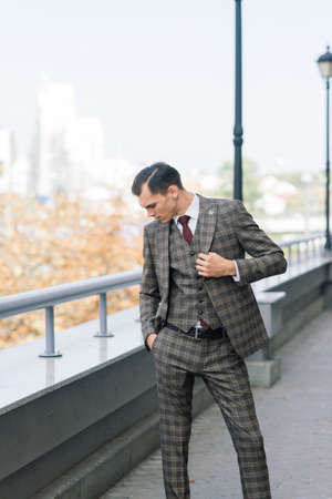 Portrait of an attractive young businessman in urban background wearing suit a necktie.の写真素材