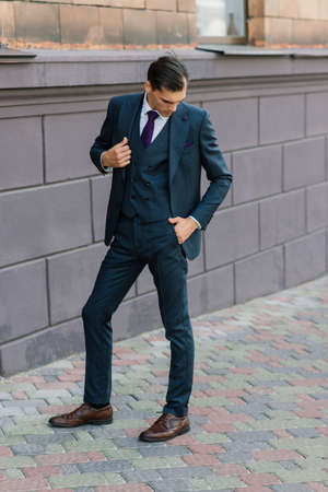 Portrait of an attractive young businessman in urban background wearing suit a necktie.の写真素材
