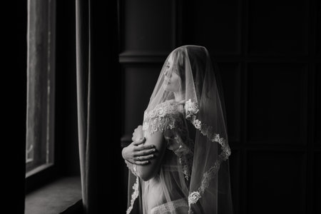 Beautiful young bride in a white lingerie. Last preparations for wedding. Girl is waiting for groom.の写真素材
