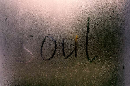 Foggy glass on a window with written finger word Soul. Concept photo with copy spaceの写真素材