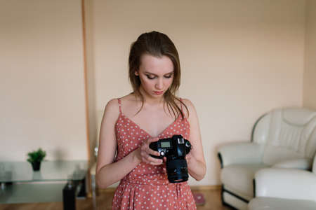 Freelance photographer woman with camera at home office editing photos on computerの写真素材