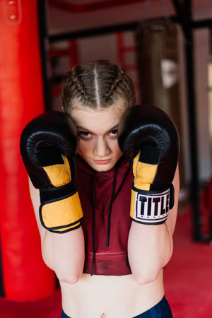 Bratislava, Slovakia - 05.25.2021. Attractive female training, punching a bag with boxing gloves onのeditorial素材