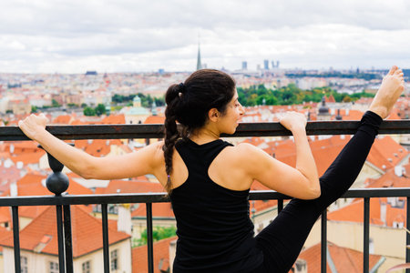 Healthy woman in a sportswear practicing yoga outdoor, doing exercise, full length portrait.