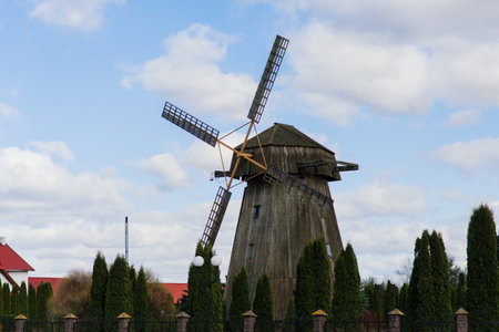 Old wooden wind mill in on sunny day. Old traditional Dutch mill.