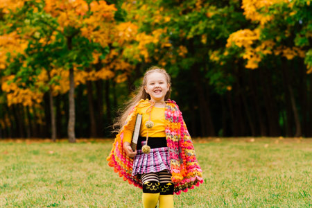 Little child, baby girl laughing and playing in autumn on the nature walk outdoorsの写真素材