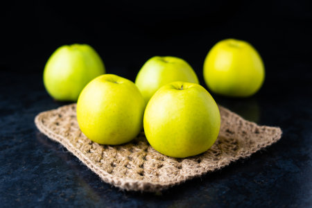 Ripe green apple fruits on a dark stone table. Top view with copy space. Flat layの写真素材