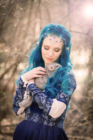 Bratislava, Slovakia - 04.14.2021. 
 Beautiful blue and blonde unusual long-haired woman in long dress holds a chinchillaのeditorial素材