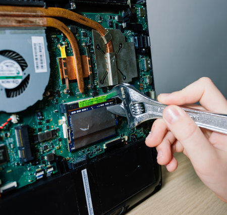 Bratislava, Slovakia - 12.14.2021. Service engineer install new chips to laptop. Repairing and upgrading laptop concept. Close up.のeditorial素材