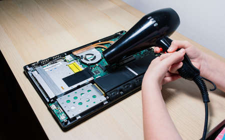 Bratislava, Slovakia - 12.14.2021. Service engineer install new chips to laptop. Repairing and upgrading laptop concept. Close up.のeditorial素材