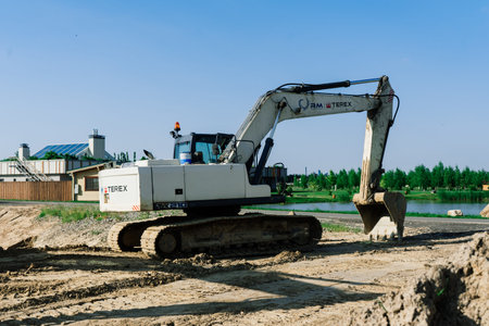 Bratislava, Slovakia - 16.06.2021. Excavator in quarry extracting stone, soil ground
