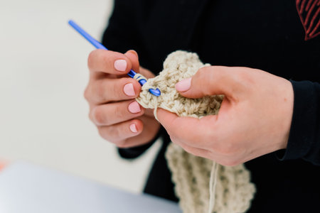 Process of a knitting isolated on white, female handsの写真素材