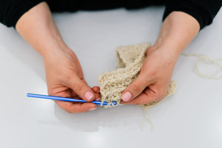 Process of a knitting isolated on white, female hands