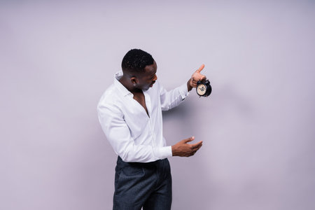 Smiling young african american man 20s wearing casual shirt eyeglasses cap standing studio portraitの写真素材