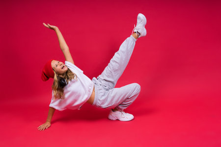 Child music concept. Teenager girl dances in rhythm of melody, listens song in headphones